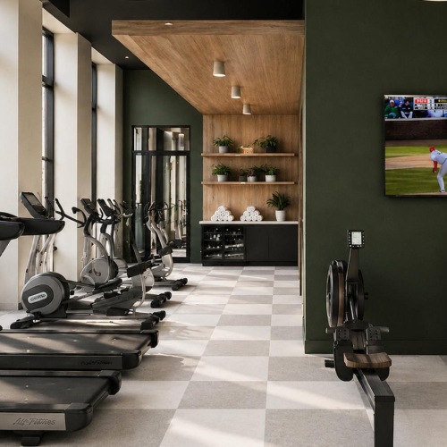 a gym with treadmills and a tv