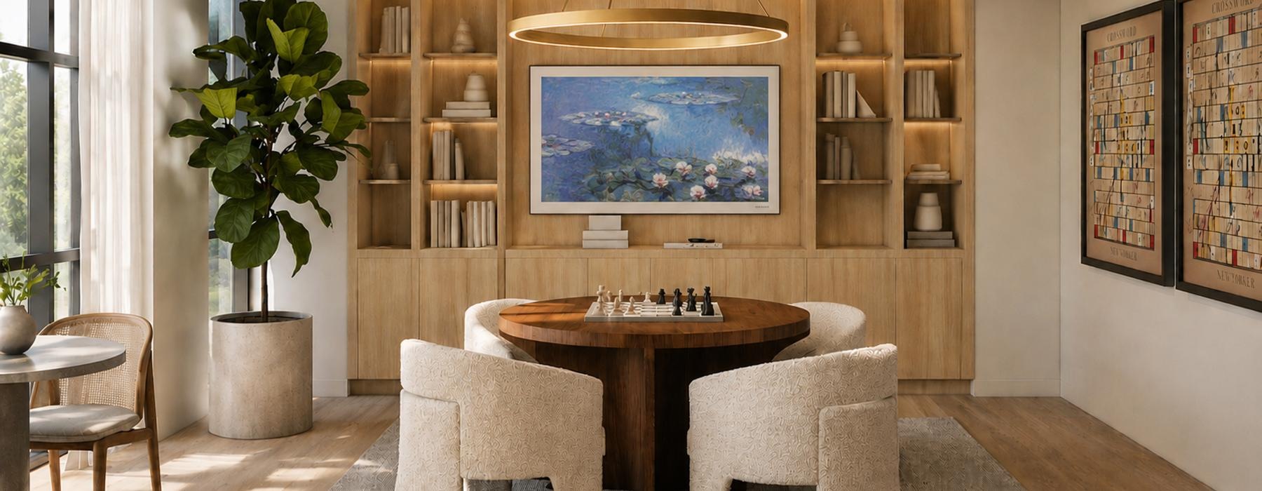 a room with a table chairs and a shelf with art on it